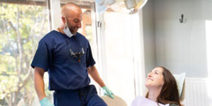 doctor smiling with patient within the dental center