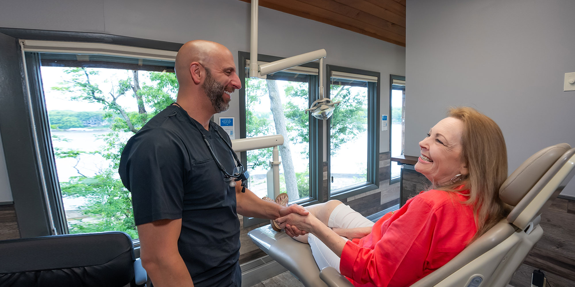 patient and doctor shaking hands within the dental center