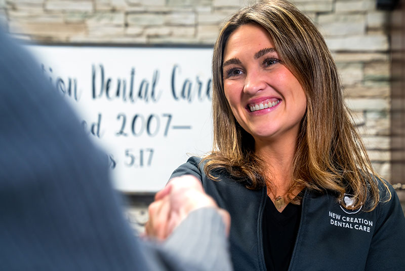 Team member greeting Patient into dental office