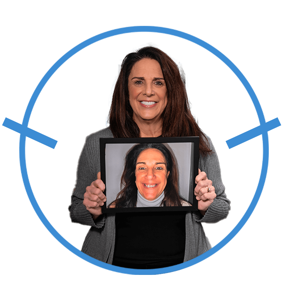 Patient holding up a before and after of their teeth