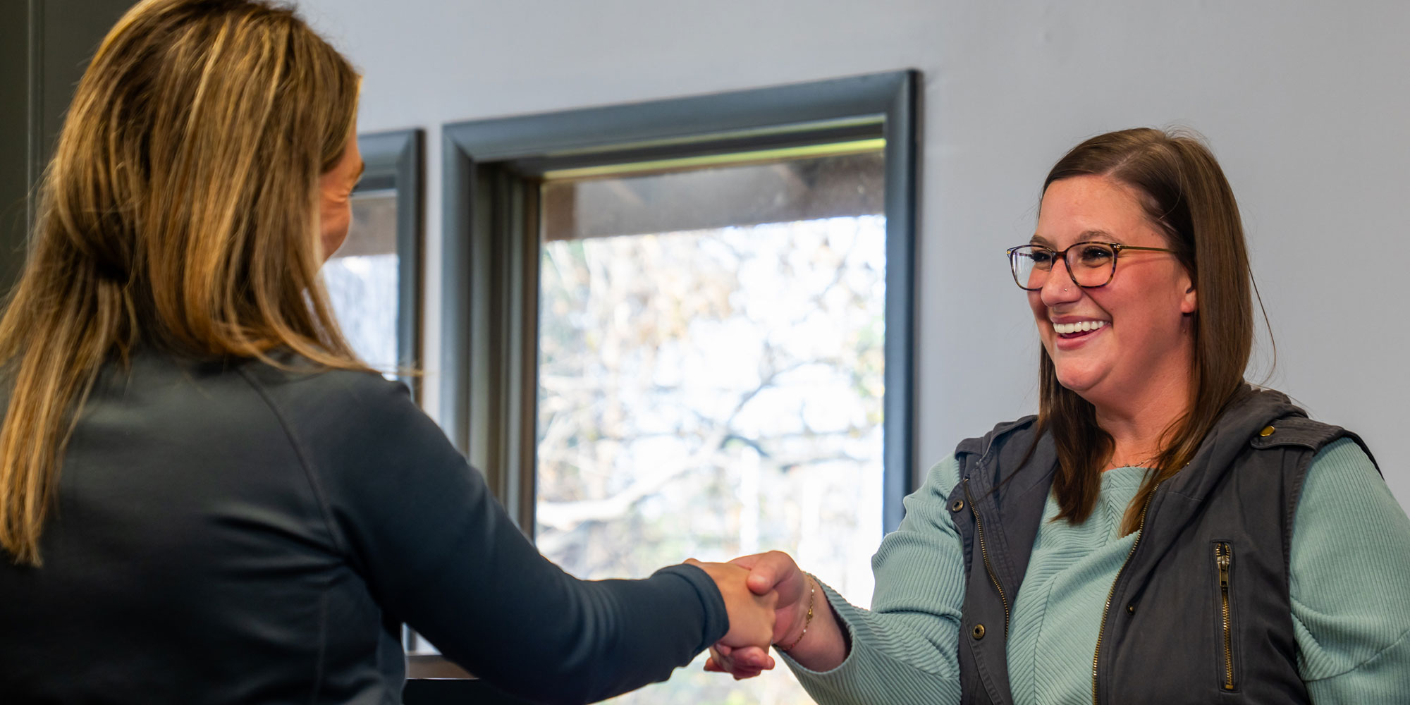 Team member and Patient shaking hands