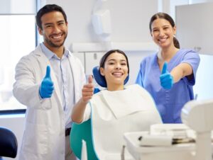 Image of a dentist placing a titanium implant into a patients jaw, with detailed view of the surgical instruments and the bone structure. No text on the image.
